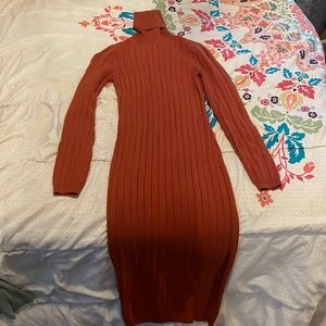 Beautiful burnt orange turtle neck dress with a cute slit on the side.